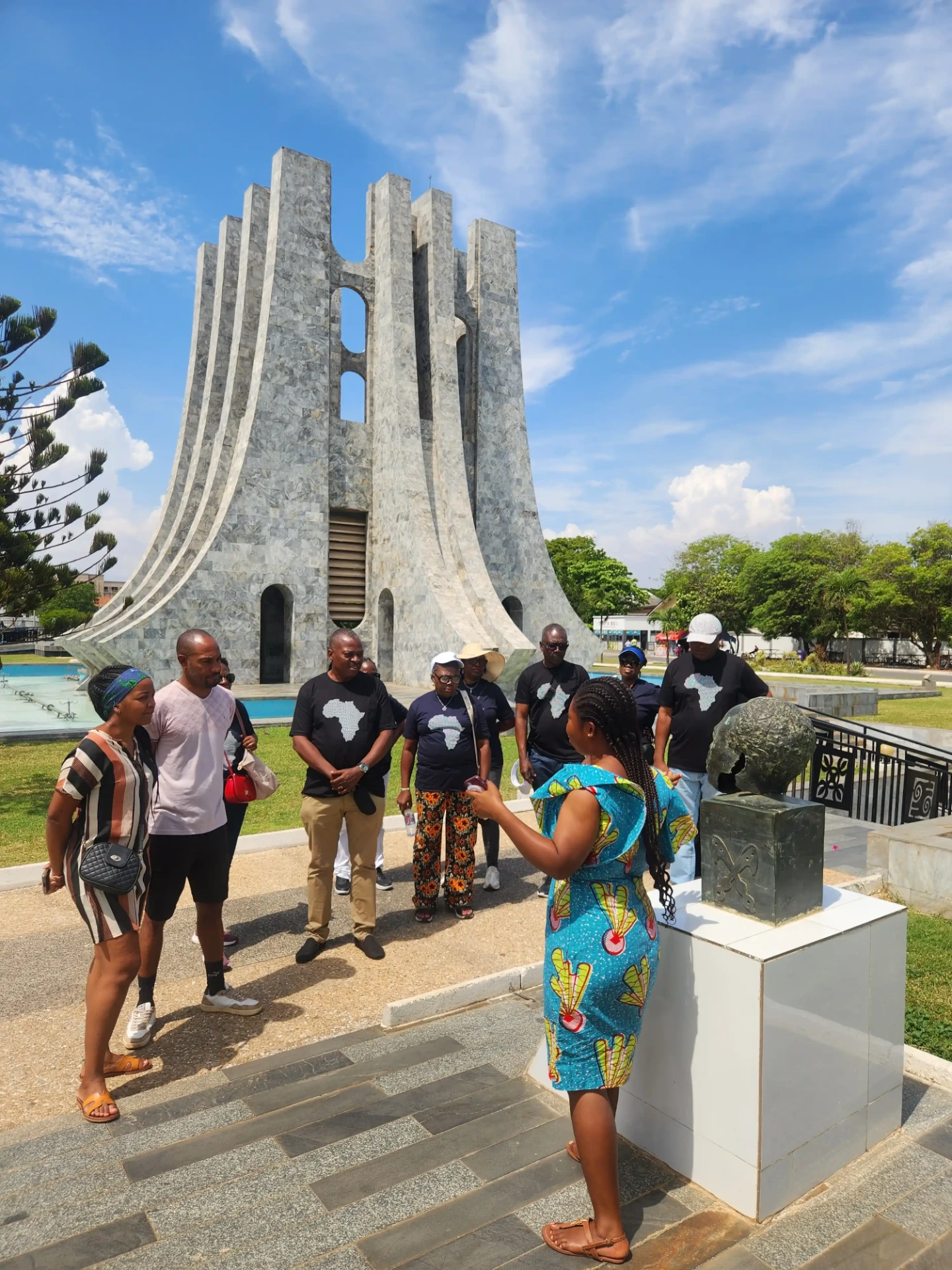 Tour guide briefing a group of visitors at the Kwame Nkrumah Memorial Park in Accra