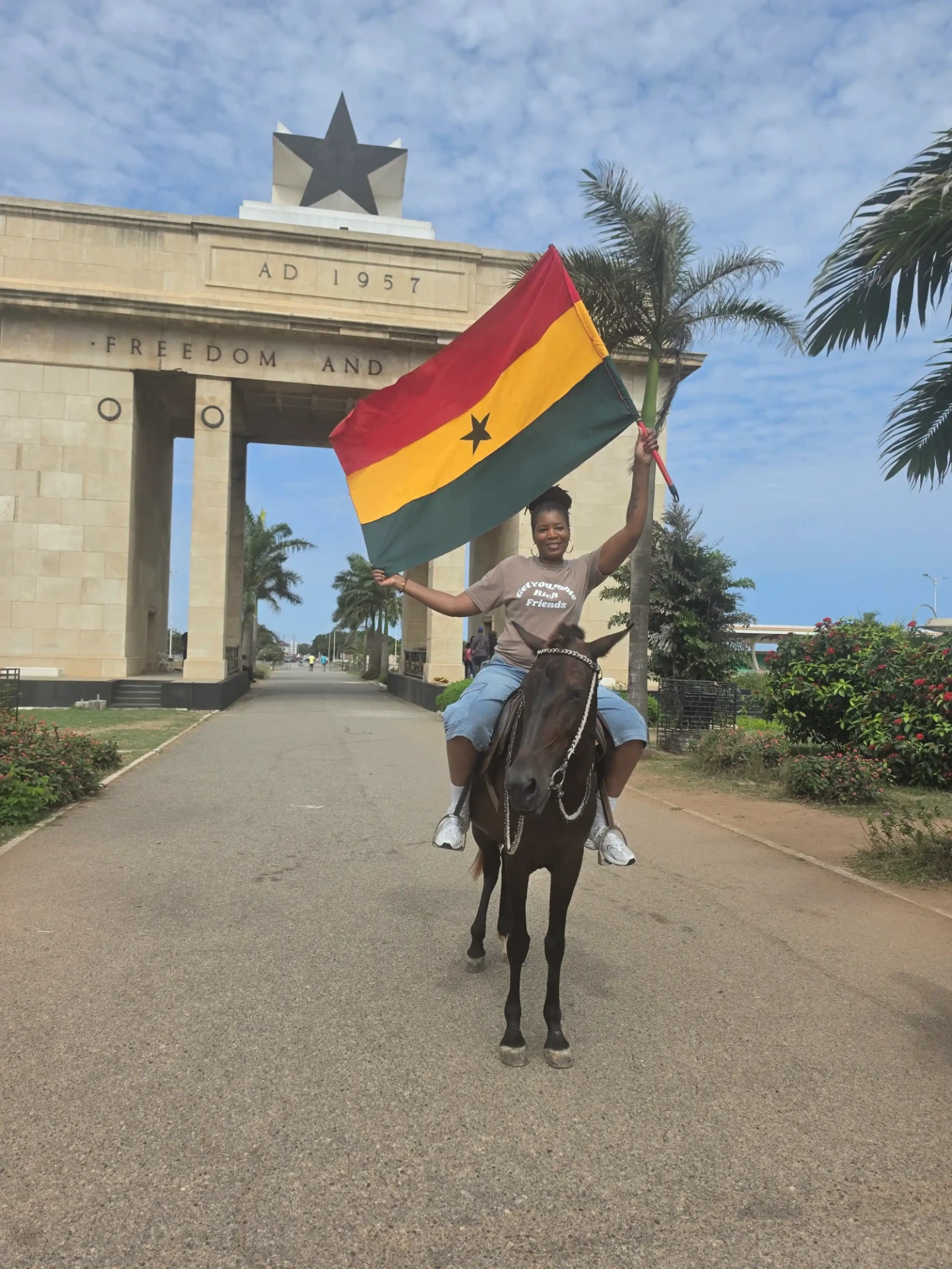 Horseback rider holding the Ghana flag at Independence Arch