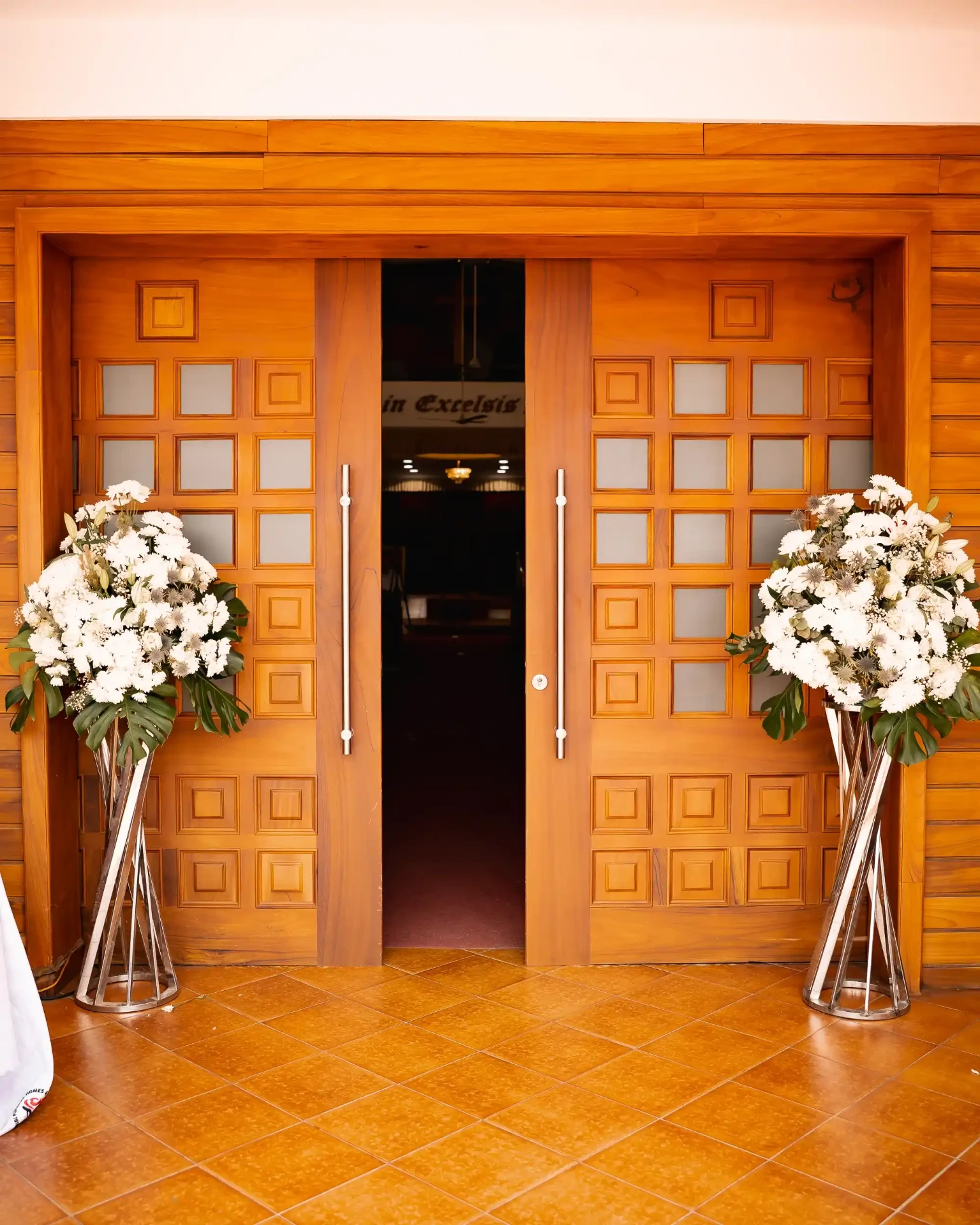 Floral tributes in a church arranged by Elated Moments for a memorial service