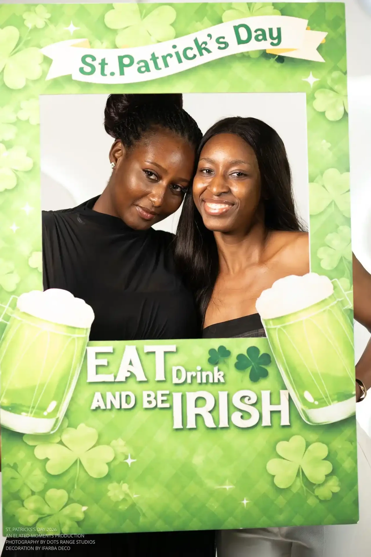 Guest posing with the Eat, drink and be Irish frame at a corporate celebration