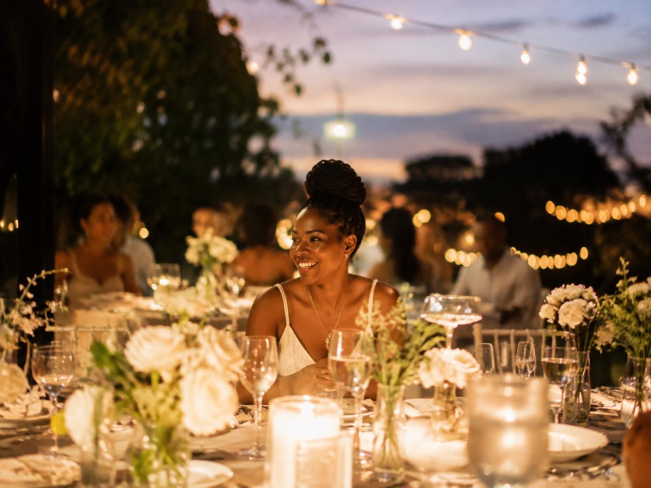 Outdoor celebration dinner under string lights (illustrative image)